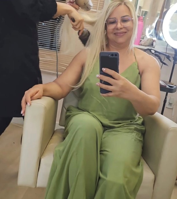 Lower-body view of a seated patient wearing a loose green outfit during treatment